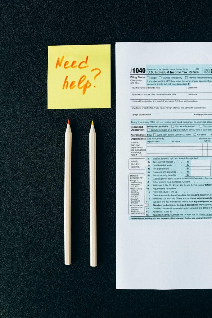 Tax documents with sticky note asking for help related to tax resolution